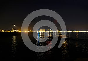 night view of the city across the seaside. Colorful lights of the city at night. Night Senigallia, Italy