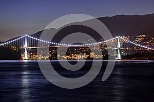 Night view of City, Bridge, Mountains, and Sea Water