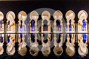 Night view of the colonnade of Sheikh Zayed Grand Mosque in Abu Dhabi, United Arab Emirate