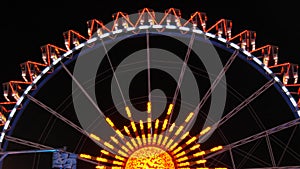 Night view of colorful glowing ferris wheel at world-famous beer festival Oktoberfest