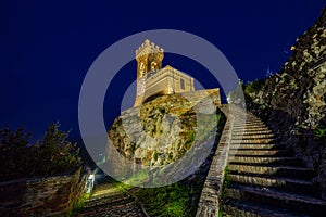 Night view of crenellated clock tower