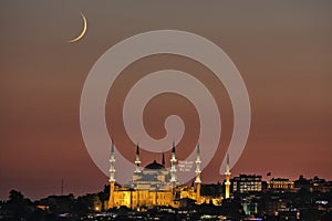 Night view with crescent moon of the Mosque of Sultan Ahmet, the Blue Mosque ramadan month mosque on the mahya, Istanbul, Turkey.