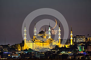 Night view with crescent moon of the Mosque of Sultan Ahmet, the Blue Mosque ramadan month mosque on the mahya, Istanbul, Turkey.