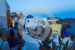 Night view of crowded narrow street Oia Santorini Greece