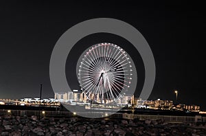 Night view of the decoratively illuminated Ferris wheel - The Dubai Eye - located on thef Dubai Marina in Dubai city, United Arab