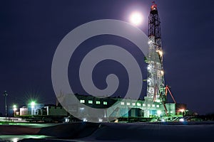 A night view of a derrick drilling in Siberia photo