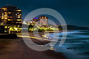 Night view of a deserted beach scene  with hotels and apartment building lights glowing