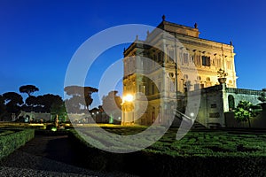 Night view at dusk of the Algardi cottage inside the public park of Villa Pamphili in Rome, Italy