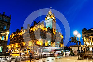 Night view of Edinburgh, Scotland with illuminated Balmoral Hotel photo
