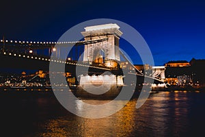 Night view of a famous Budapest Szechenyi Chain Bridge, a suspension bridge that spans the River Danube between Buda and Pest, the