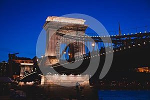 Night view of a famous Budapest Szechenyi Chain Bridge, a suspension bridge that spans the River Danube between Buda and Pest, the