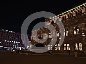 Night view of the famous Vienna State Opera house in the center of Vienna, capital of Austria, with illuminated windows.