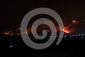 Night view of a fire in the mountains photo