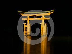 A night view of the floating torii gate at UNESCO World Heritage Itsukushima Shrine on the island of Miyajima in Japan