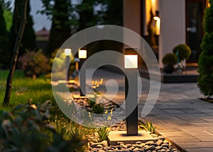 Night View Of Flowerbed Illuminated By Energy-Saving Solar Powered Lantern On Courtyard. Beautiful Small Garden Light