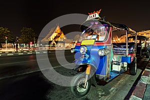 Night view of The Giant Swing and rickshaw taxi tuk-tuk and light trail