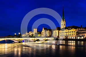 Night view of historic Zurich city center with famous Fraumunster Church and river Limmat in Zurich, Switzerland