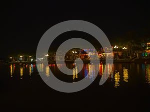 Night view of Hoian city reflection in the river in Hoi AN, Vietnam photo