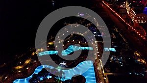 Night view of hotel with swimming pools and lights
