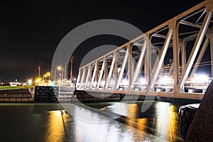 Night view of illuminated bridge above of river Scheldt in Antwerp, Belgium