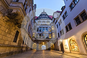 Night view of illuminated narrow street with old historic buildings of Dresden city, Germany.