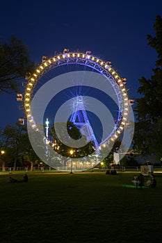 Night view of the illuminated Riesenrad ferris wheel in the Prat