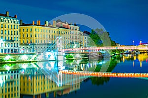 Night view of illuminated riverside of Saone river in Lyon, France