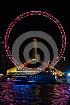 Night view of the illuminated Tianjin Eye ferris wheel in Tianjin