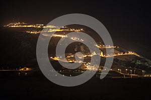 Night view of Jebel Hafeet and the lit road, Al Ain, UAE