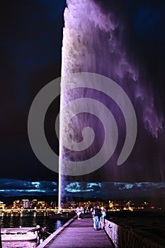 Night view of the Jet d\'Eau, a large fountain in Geneva, Switzerland and is one of the city