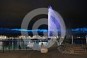 Night view of the Jet d\'Eau, a large fountain in Geneva, Switzerland and is one of the city