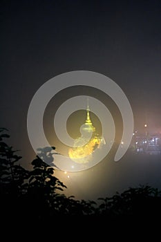 Night view of kyaiktiyo pagoda or Golden Rock with fog background are pagoda is famous tourist attraction in Mon state, Myanmar