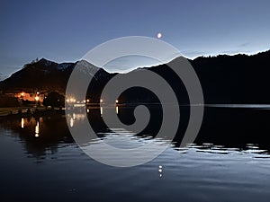 Night view of the lake Schliersee and crescent moon over the Bavarian Alps, Bavaria, Germany, November 2022