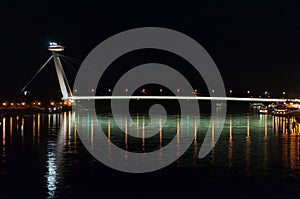 Night view of the lighted SNP bridge over Danube river. Bratislava, Slovakia