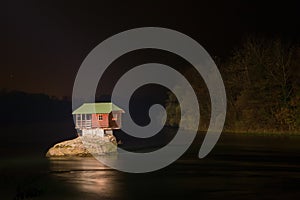Night view of Lonely house on the river Drina in Bajina Basta photo