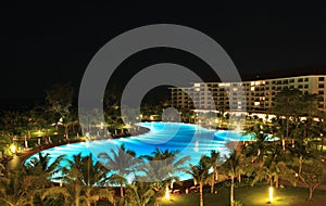 Night view of a luxury resort with huge swimming pool