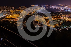 Night view of Malaga with Port and Placa de Torros from castle