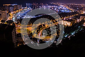Night view of Malaga with Port and Placa de Torros from castle