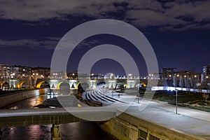 Night view of the Manzanares river in Madrid with the old bridge