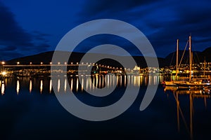 Night view of marina area in Tromso with Tromso Bridge in the distance