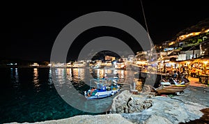 Night view of Matala village restaurants in Crete, Greece