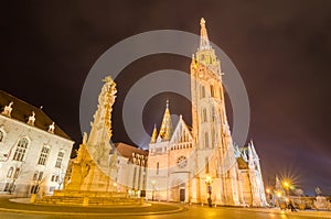 Night view of the Matthias Church and Statue of Holy Trinity, Budapest, Hungary.