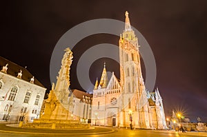 Night view of the Matthias Church and Statue of Holy Trinity, Budapest, Hungary.