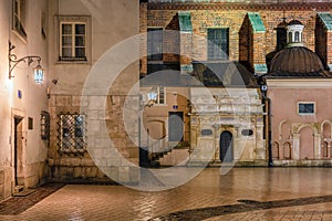 Night view medieval buildings near main market Square Krakow, Poland