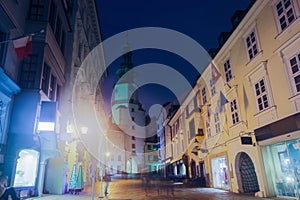 Night view of Michael Gate with a tower in Bratislava, Slovakia