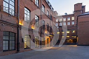 Night view. Modern Loft-style offices located in the old factory building. Red brick houses. Vintage. Buildings with large Windows photo