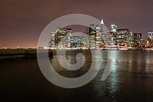 Night view of the most emblematic buildings and skyscrapers of Manhattan (New York). Brooklyn bridge. River Hudson. photo