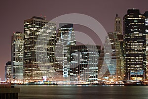 Night view of the most emblematic buildings and skyscrapers of Manhattan (New York). Brooklyn bridge. River Hudson. photo