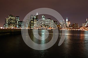 Night view of the most emblematic buildings and skyscrapers of Manhattan (New York). Brooklyn bridge. River Hudson. photo