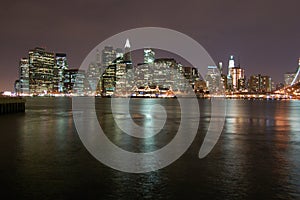 Night view of the most emblematic buildings and skyscrapers of Manhattan (New York). Brooklyn bridge. River Hudson. photo